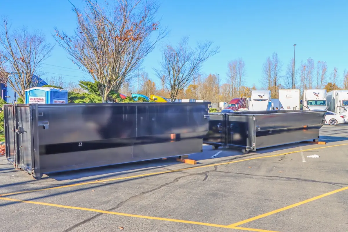 Professional dumpster rental service with roll-off container on residential driveway in Brandywine